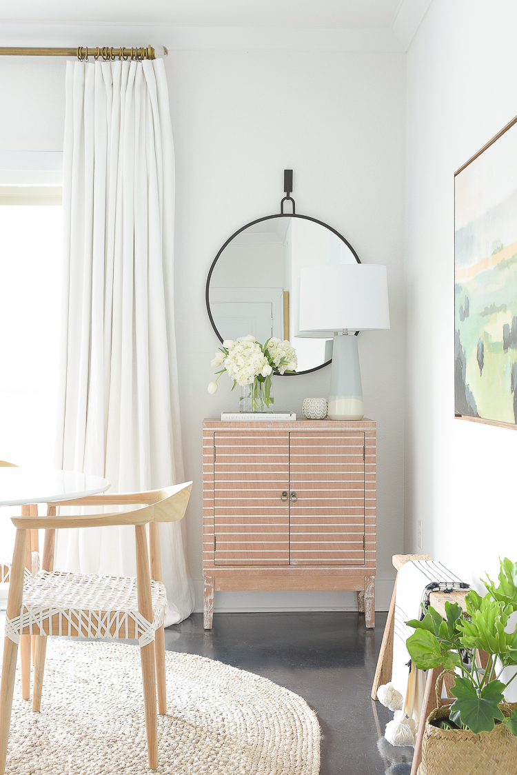 ZDesign At Home Spring Dining Room Tour - modern wooden bar cabinet, round black mirror, round jute rug, custom white linen curtains