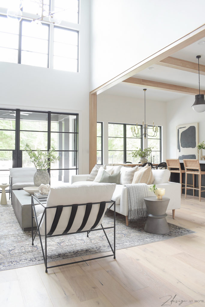 open airy living room with steel doors and soaring windows