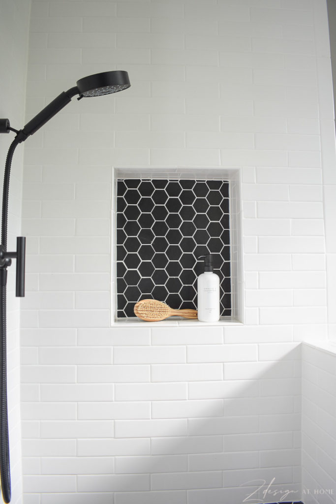 niche for dog wash with white tile and black hex tile with white grout