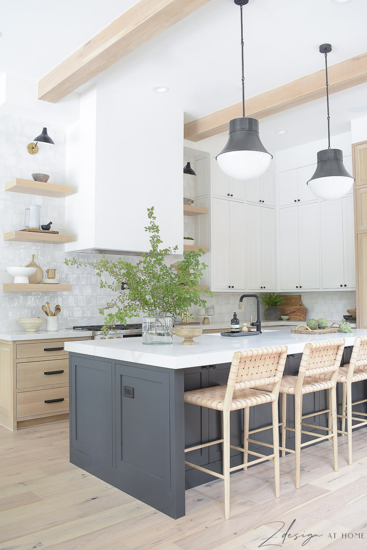 https://www.zdesignathome.com/wp-content/uploads/2021/09/modern-farmhouse-kitchen-white-sheetrock-range-hood-white-oak-shelves-kitchen-with-three-cabeinet-colors-kelley-wearstler-precision-pendant-lattice-barstools-4.jpg