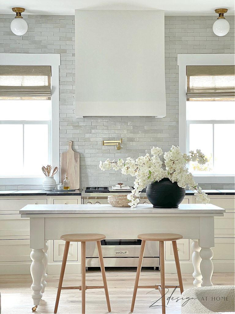 https://www.zdesignathome.com/wp-content/uploads/2023/07/Zdesign-at-home-english-cottage-kitchen-renovation-reveal-benjamin-moore-natural-cream-toe-kick-riad-tile-thin-zellige-backsplash-snow-white-two-kinds-countertop-one-space-french-range-hood-cf.jpg