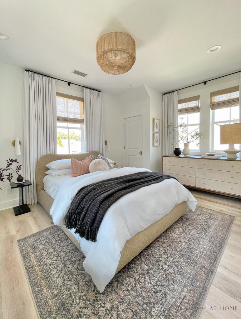 transitional modern neutral bedroom with white linen curtains and bedding