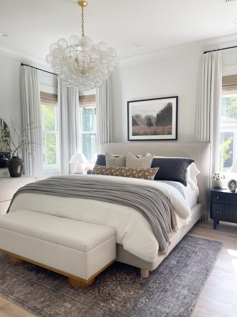 neutral primary bedroom with pattern and color pops