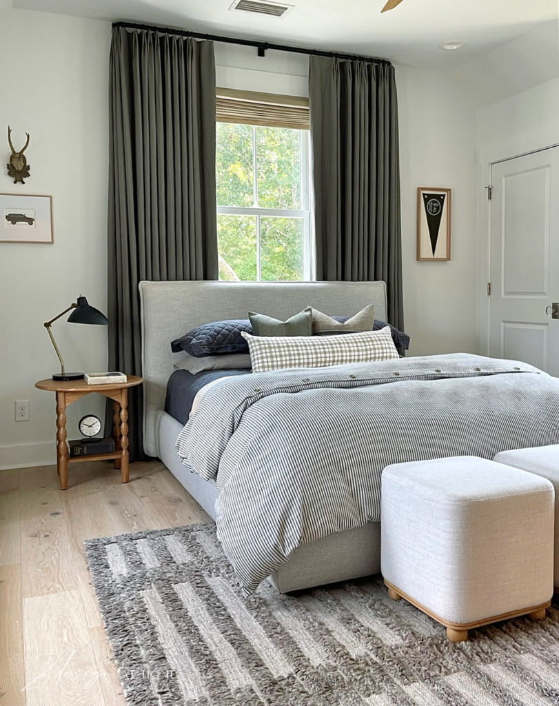 gray flange upholstered queen bed in teen boys bedroom