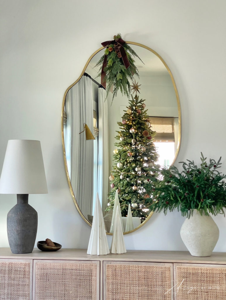 modern simple christmas decor with swag on mirror and brown velvet ribbon, pinecone norfolk pine stems 